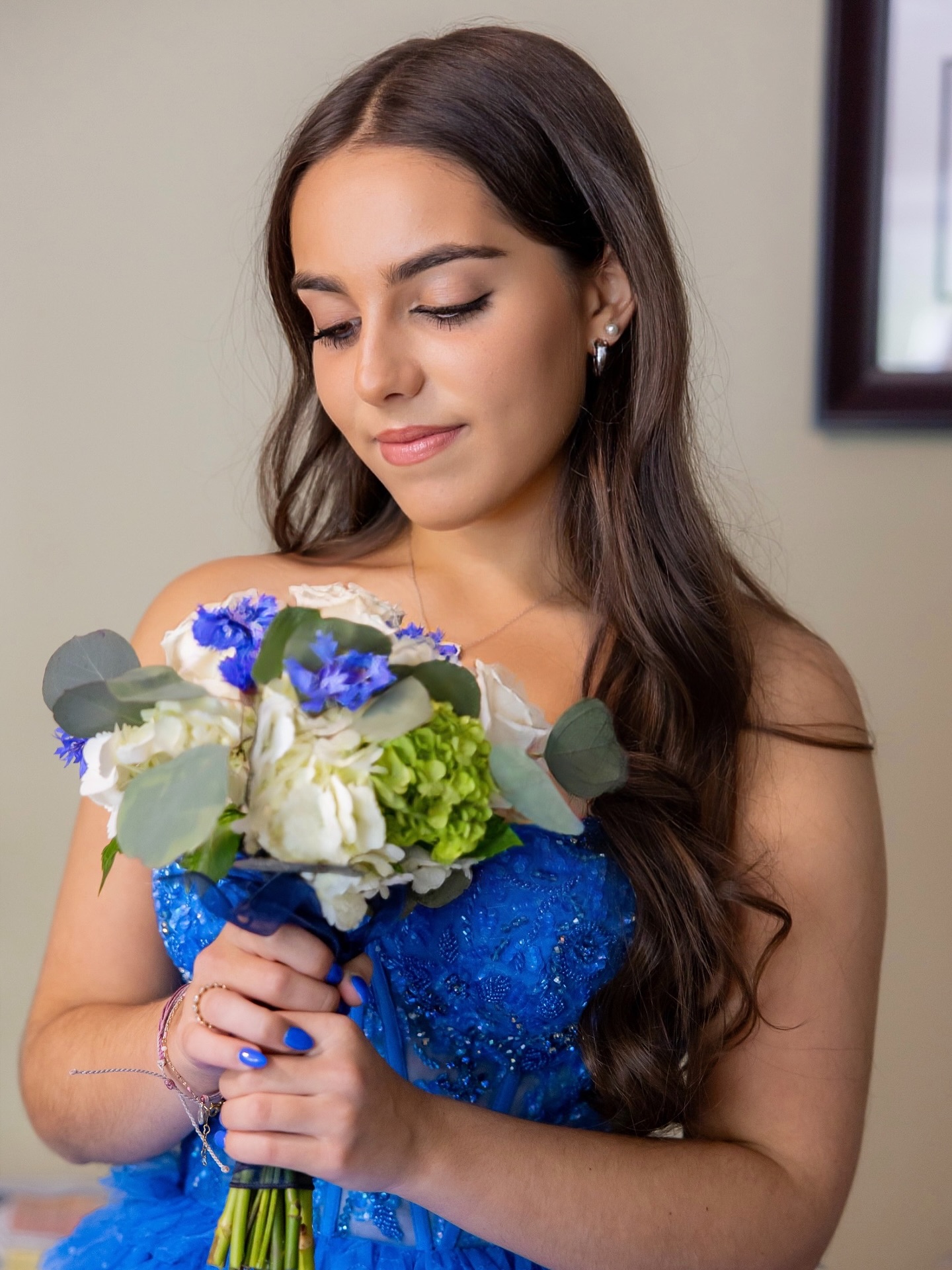 Formal portrait with a bouquet in a royal blue gown