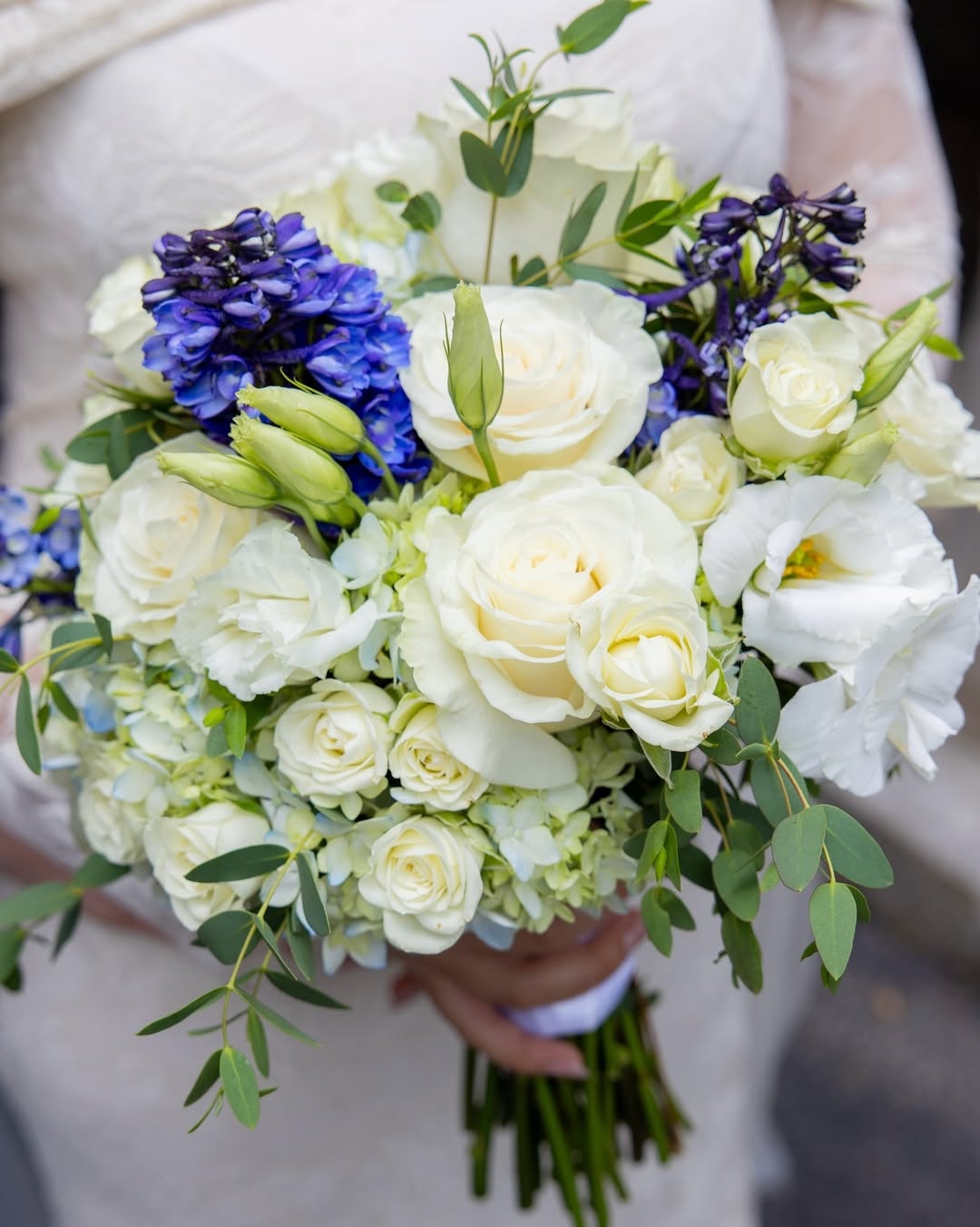 Close-up of the bridal bouquet against the wedding dress